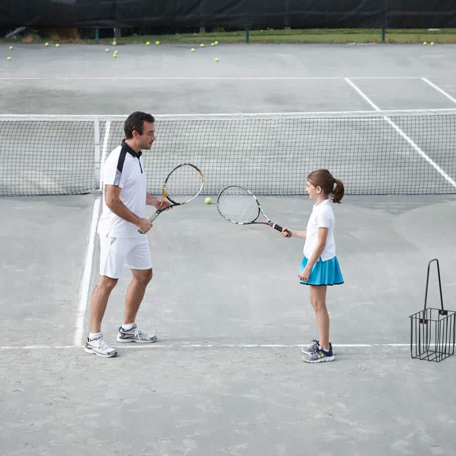 Father and daughter playing tennis